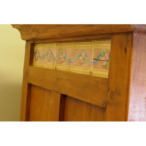 1097 - An antique teak cabinet with glazed and painted doors to the upper section and a tiled frieze, 118 x... 