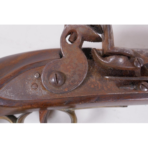 110 - A late C18th/early C19th flintlock pistol, barrel 23cm long, the lock stamped Tower on a crown over ... 