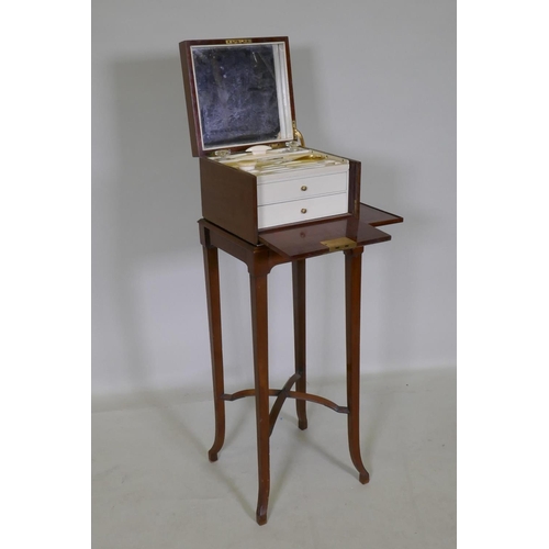 1104 - A mahogany vanity chest with fitted interior and two drawers, the top with a mirror, bears label Joh... 