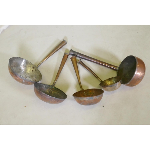 112 - A collection of Middle Eastern copper cooking vessels, longest 58cm