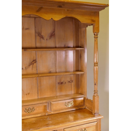 1120 - A pine dresser, the upper section with delft rack over four drawers, open sides, the base with four ... 