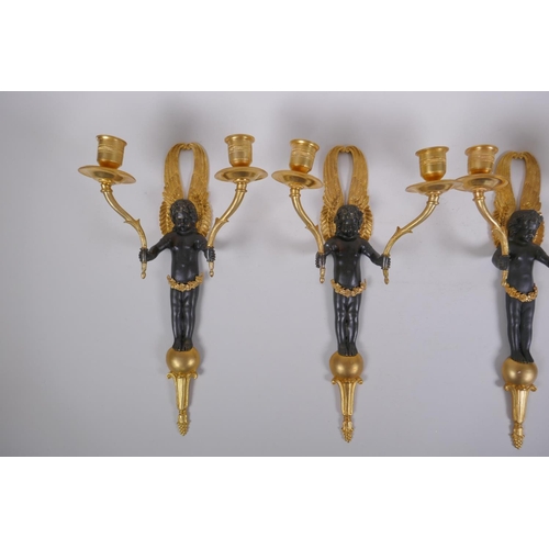 114 - Two pairs of ormolu and bronze two branch candle sconces in the form of winged putti, 34cm high