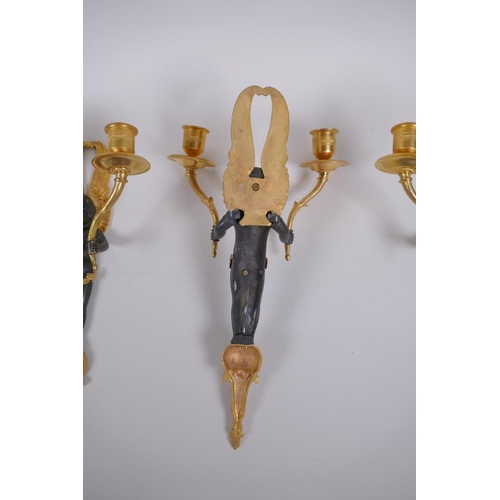 114 - Two pairs of ormolu and bronze two branch candle sconces in the form of winged putti, 34cm high