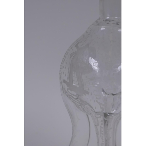 117 - An antique glass bottle of pinched waist form and etched decoration, 28cm high
