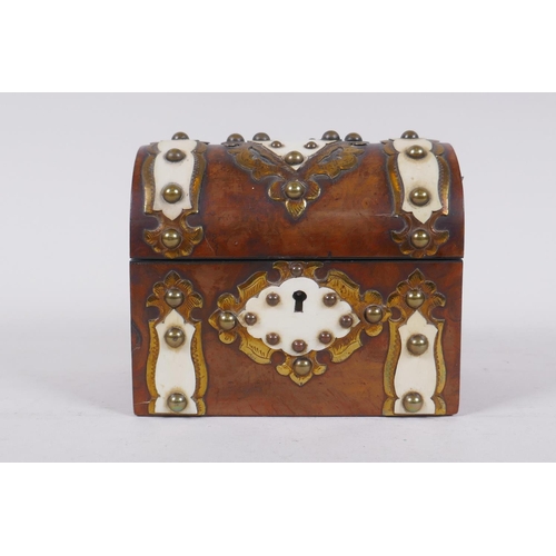 12 - A Victorian figured walnut dome top scent bottle box, with brass and ivory mounts, lined with watere... 