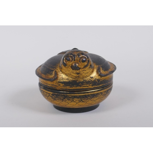 120 - An antique oriental gilt and black lacquer box in the form of a bird, 9cm diameter