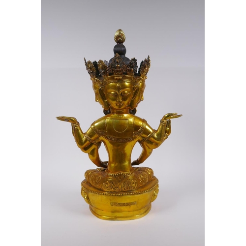 122 - A large Sino Tibetan gilt bronze figure of a deity with many arms and faces, impressed double vajra ... 