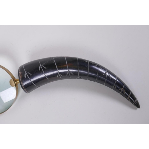 124 - A horn handled brass mounted magnifying glass, 32cm long