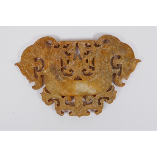 125 - A Chinese carved and pierced hardstone pendant with stylised twin dragon decoration, 14 x 9cm