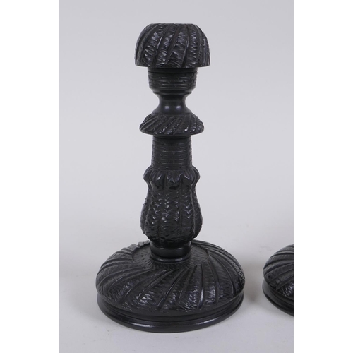 127 - A pair of Anglo Indian carved ebony candlesticks, 14cm high