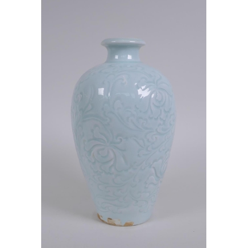 130 - A Chinese celadon glazed porcelain vase with incised lotus flower decoration, 22cm high
