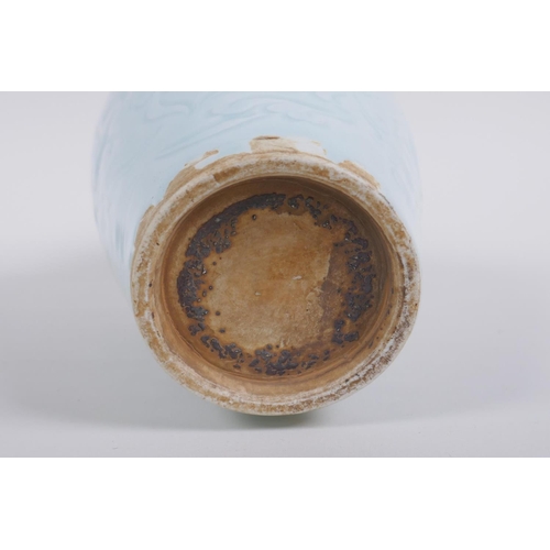 130 - A Chinese celadon glazed porcelain vase with incised lotus flower decoration, 22cm high