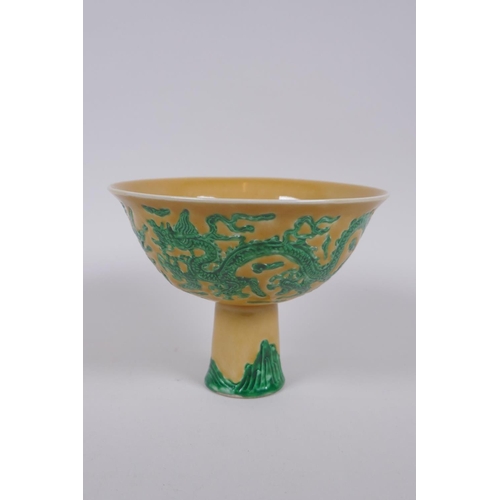 135 - A Chinese yellow ground porcelain stem bowl with raised green enamelled dragon decoration, Xuande 6 ... 