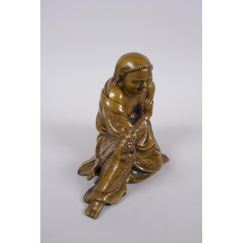 136 - A Chinese filled bronze figure of Lo-han, 18cm long