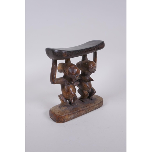 142 - An African Luba tribe carved wood head rest, 18cm high