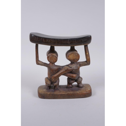 142 - An African Luba tribe carved wood head rest, 18cm high