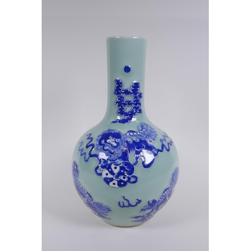 143 - A Chinese celadon ground porcelain bottle vase with raised blue and white kylin decoration, 35cm hig... 