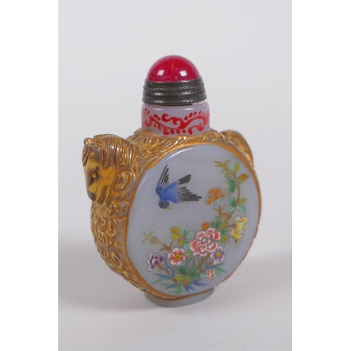150 - A Peking glass snuff bottle with carved and gilt horse decoration, the side panels with polychrome e... 