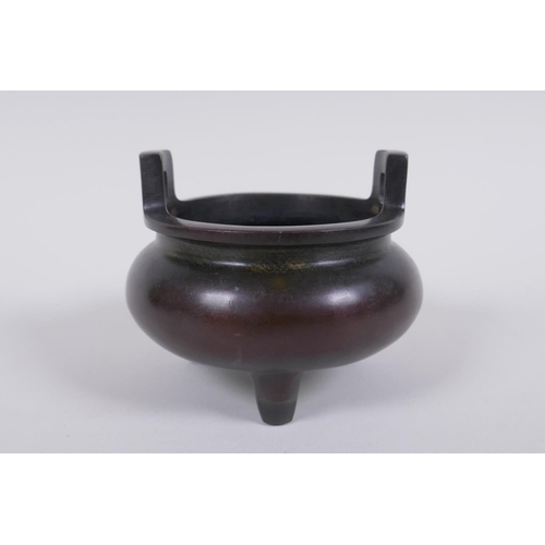 163 - A Chinese bronze two handled censer raised on tripod supports, 9cm high x 10cm diameter