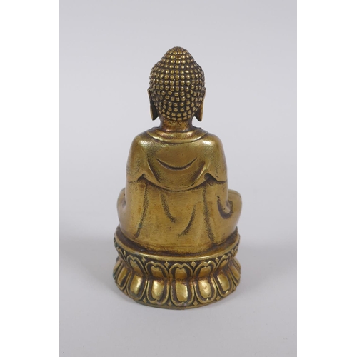 165 - A Sino Tibetan filled bronze Buddha, double vajra mark to base, 11cm high