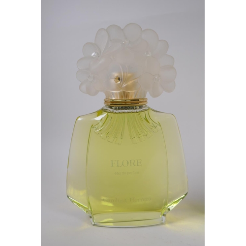 17 - An oversized Carolina Herrera Flore perfume display bottle, and a similar Antonio Puig Sybaris after... 
