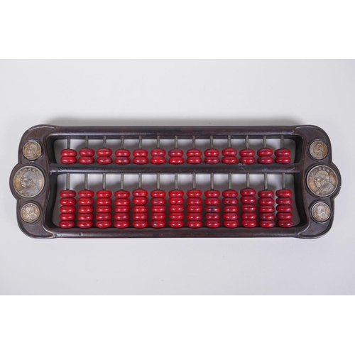 173 - A Chinese hardwood and red stone abacus set with decorative white metal coins, 42 x 14cm