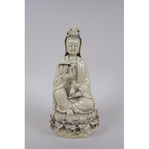 175 - A Chinese blanc de chine porcelain Quan Yin seted on a lotus flower, impressed mark verso, 26cm high