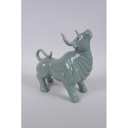 180 - A Chinese celadon glazed porcelain figure of a buffalo, AF repair, 22cm long