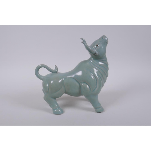 180 - A Chinese celadon glazed porcelain figure of a buffalo, AF repair, 22cm long