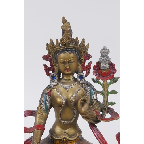 185 - A Sino Tibetan cold painted metal figure of a female deity, 21cm high