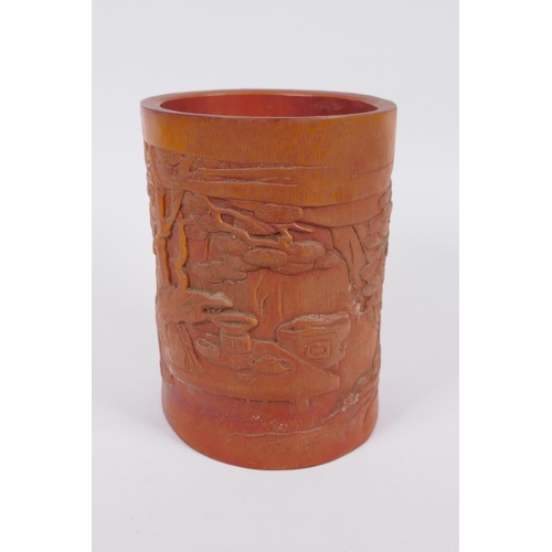 186 - A Chinese bamboo brush pot with carved decoration of Lo-han in a landscape, 16cm high