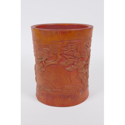 186 - A Chinese bamboo brush pot with carved decoration of Lo-han in a landscape, 16cm high