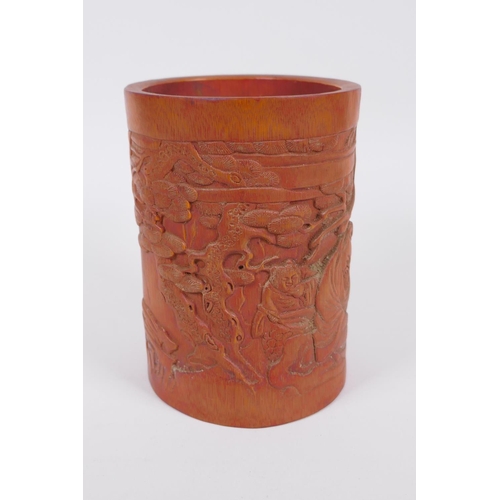 186 - A Chinese bamboo brush pot with carved decoration of Lo-han in a landscape, 16cm high