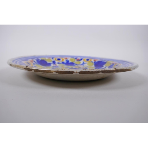 187 - An C18th/C19th tin glazed majolica charger with floral decoration, possibly Delft, hairline, 31cm di... 