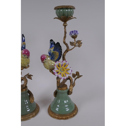 201 - A pair of polychrome porcelain and gilt metal candlesticks decorated with birds and flowers, 32cm hi... 