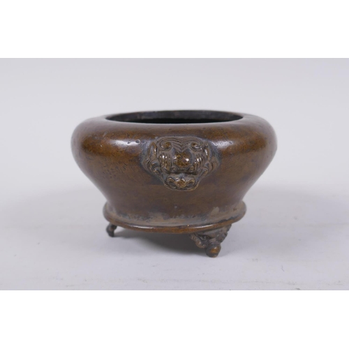 202 - A Chinese bronze censer on tripod supports with two fo dog mask handles, impressed mark to base, 12c... 