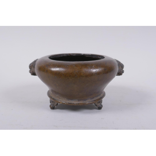 202 - A Chinese bronze censer on tripod supports with two fo dog mask handles, impressed mark to base, 12c... 