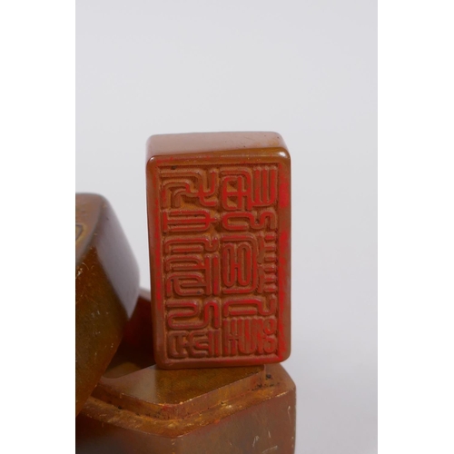 205 - A Chinese soapstone box and cover opening to reveal a seal, the cover with carved Buddha decoration,... 