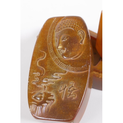 205 - A Chinese soapstone box and cover opening to reveal a seal, the cover with carved Buddha decoration,... 