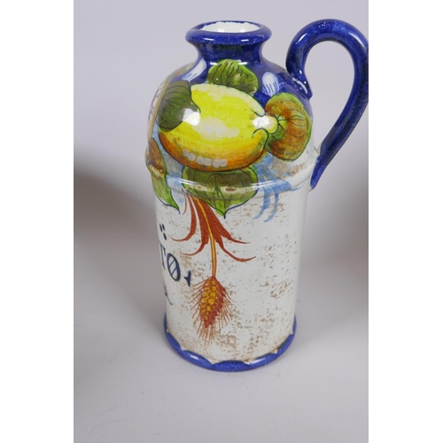 214 - A collection of Italian Majolica to include a vinegar bottle, bramble wine jug, a tureen with cover ... 