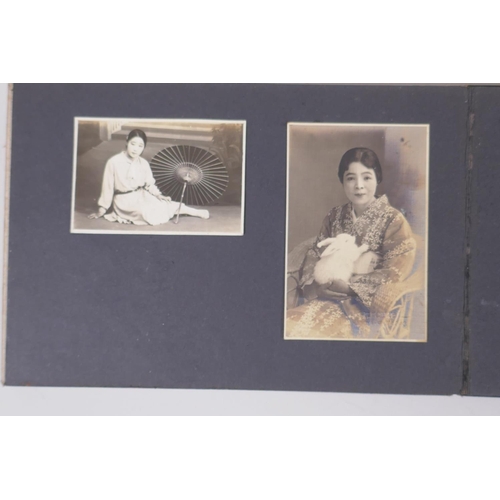 222 - A Japanese photograph album containing portrait photographs from the late C19th and early C20th