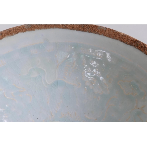 228 - A Chinese Song style celadon glazed porcelain dish of conical form, with underglaze decoration of a ... 