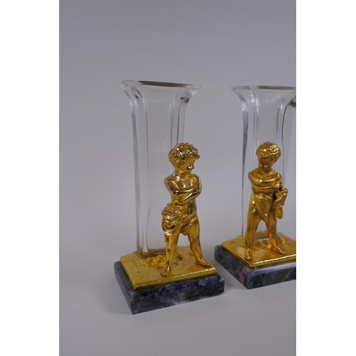 237 - A pair of gilt bronze glass stem vases with figural decoration of a child, after Louis Kley, mounted... 