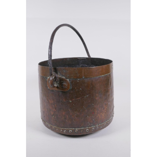 239 - An Indian brass planter with engraved decorative figural panels, and an antique riveted copper bucke... 