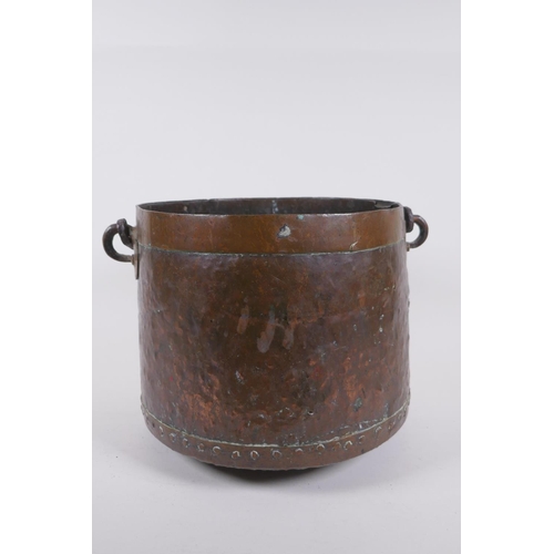 239 - An Indian brass planter with engraved decorative figural panels, and an antique riveted copper bucke... 