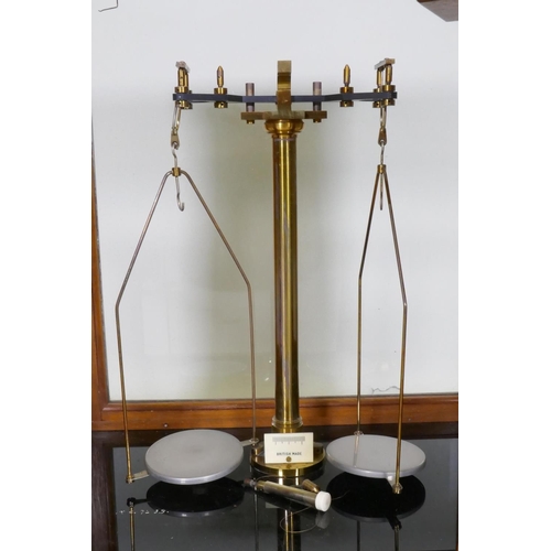 247 - A set of balance scales in a glazed wood cabinet, 43 x 30 x 50cm