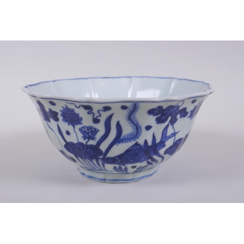 250 - A blue and white porcelain steep sided bowl with lobed rim, decorated with carp in a lotus pond, Chi... 