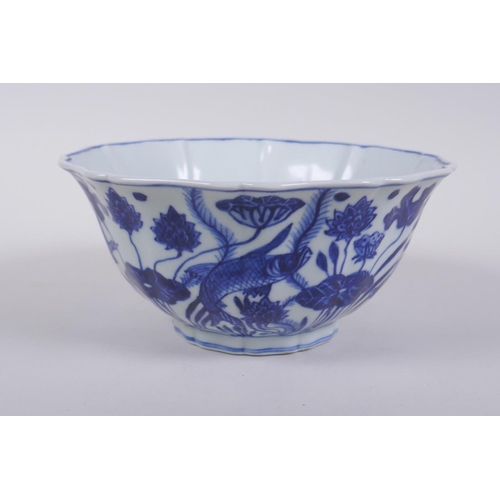 250 - A blue and white porcelain steep sided bowl with lobed rim, decorated with carp in a lotus pond, Chi... 