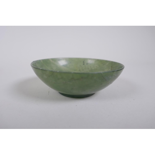 266 - Four Chinese spinach jade bowls, AF repairs, 7cm diameter