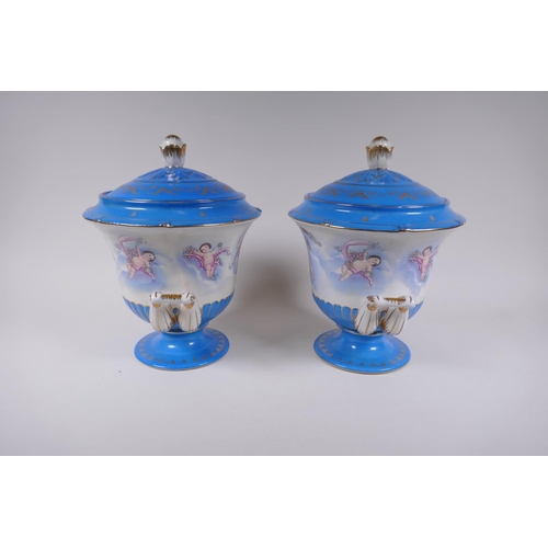 284 - A pair of Sevres style porcelain urns and covers with two handles, decorated with winged putti, 28cm... 